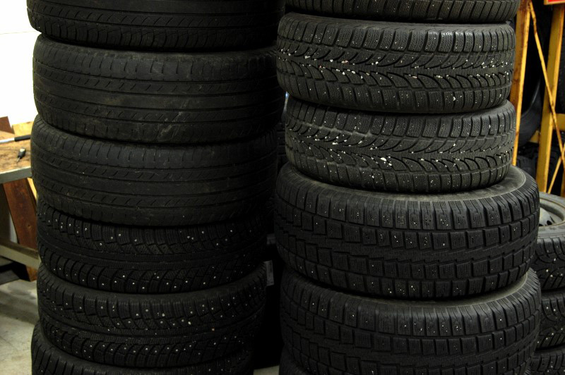 Storing winter and summer tires inside in pile