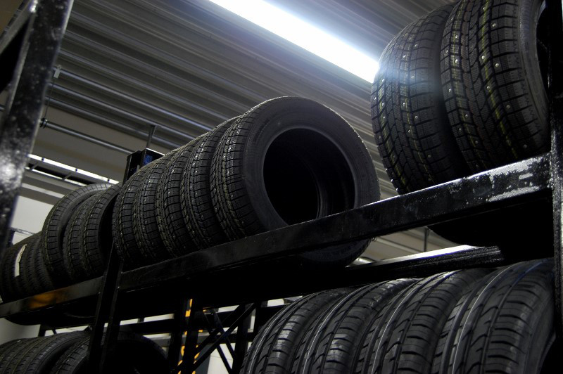 Storing winter and summer tires inside on tire rack